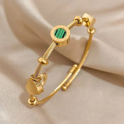 Golden Bracelet with a Green Gemstone